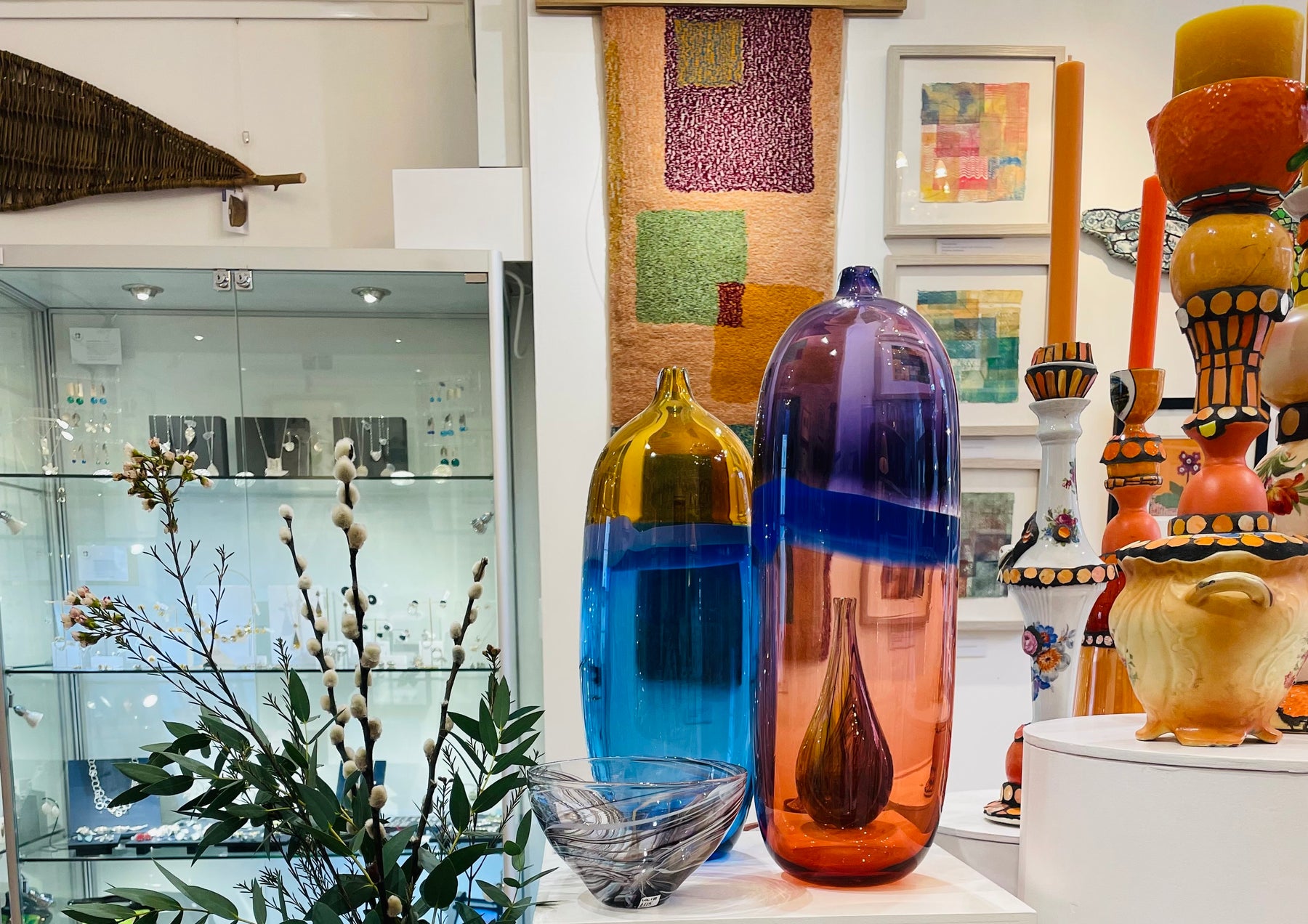 colourful galss vases and ceramics in a shop setting